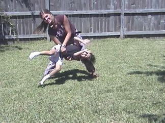 Natalie teaching Suzannah how to do a cartwheel