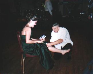Patrick putting the garter on Anika