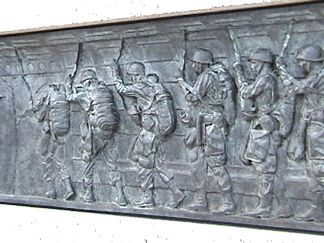One of Many plaques along the WWII Memorial depecting patriotism from citizens at home and soldiers at the front