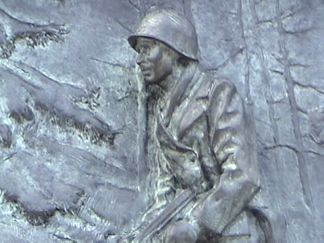 One of Many plaques along the WWII Memorial depecting patriotism from citizens at home and soldiers at the front