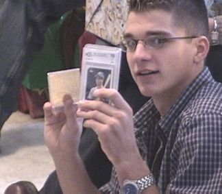 Patrick showing the collectors baseball cards he got from his Uncle Mike