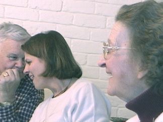 Mom looks on as Fr. Jesse and Joanie do some scheming